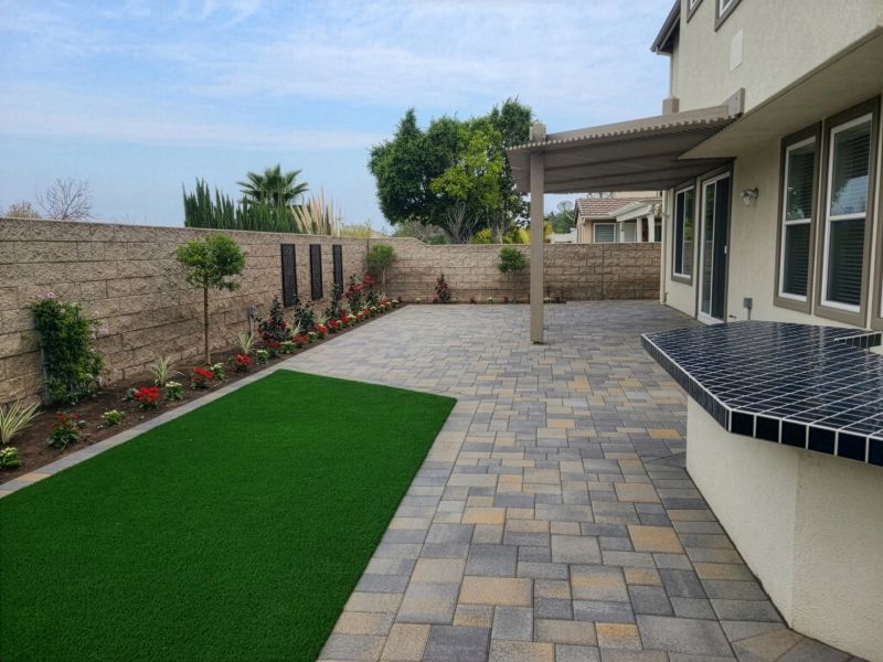 Backyard with grass pavers plants table 